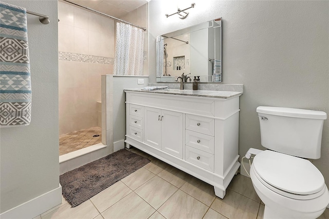 full bath with tile patterned flooring, toilet, vanity, and tiled shower