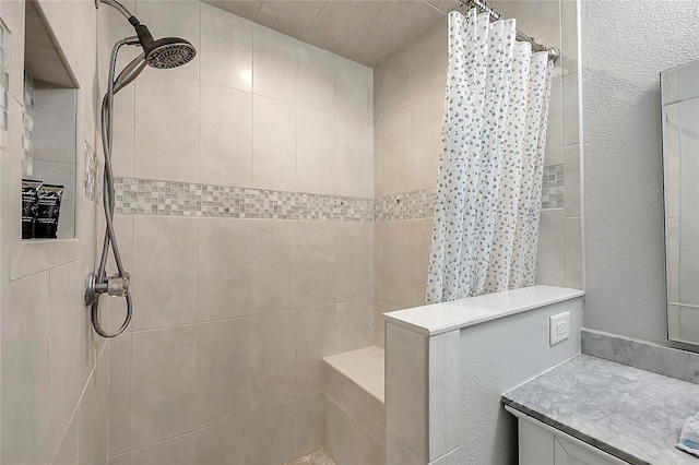 full bathroom with vanity and a tile shower