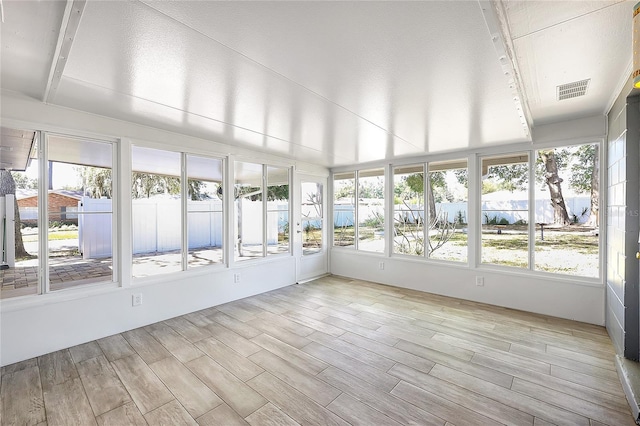 unfurnished sunroom featuring visible vents