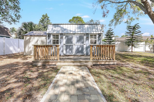 view of shed featuring fence