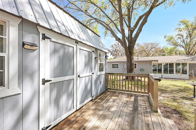 wooden deck with a sunroom