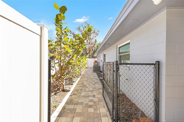 view of property exterior with fence and a gate