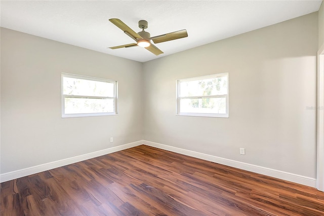 unfurnished room featuring ceiling fan, baseboards, plenty of natural light, and dark wood-style floors