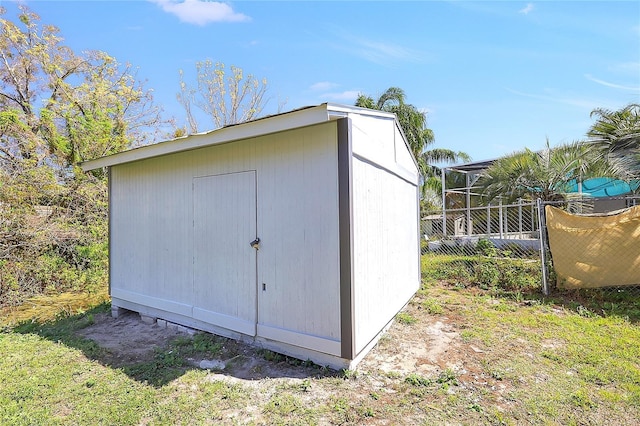 view of shed with fence