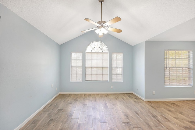 spare room with baseboards, light wood-type flooring, and ceiling fan