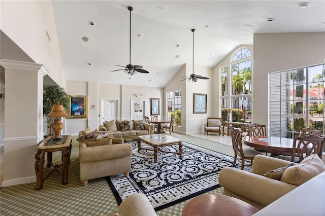 living room with ceiling fan, carpet, baseboards, and high vaulted ceiling