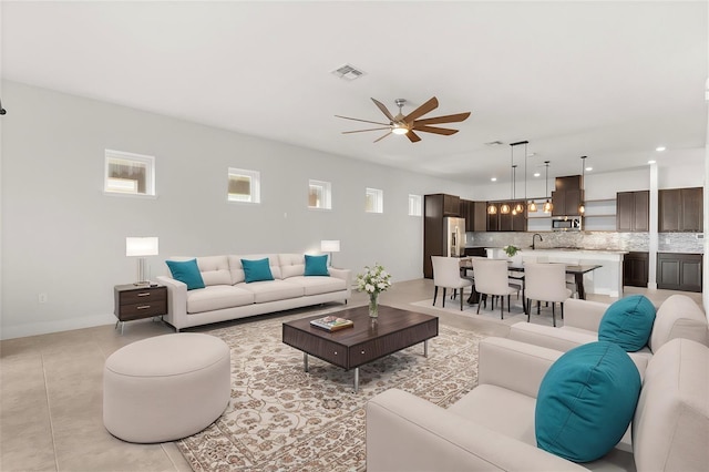 living room with visible vents, recessed lighting, baseboards, and a ceiling fan