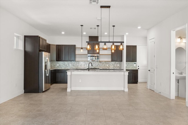 kitchen featuring open shelves, a sink, stainless steel appliances, dark brown cabinetry, and light countertops