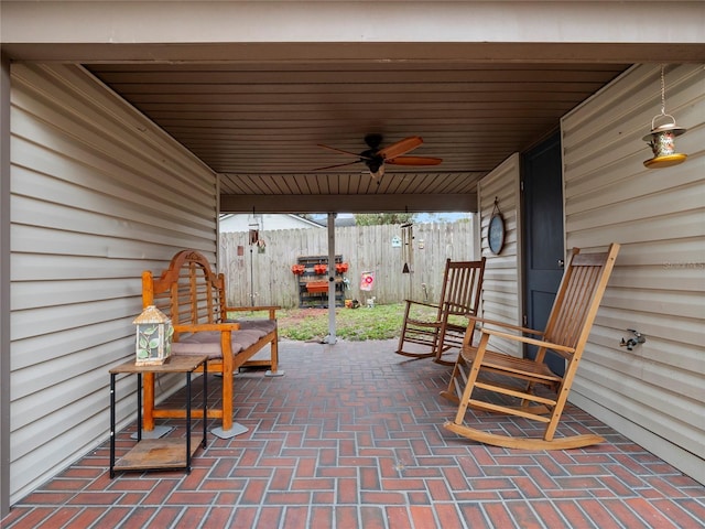 view of patio with a ceiling fan and fence