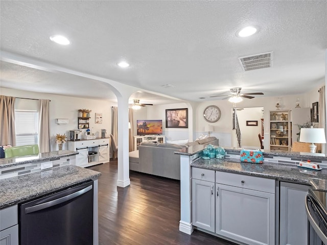 kitchen with visible vents, ceiling fan, dark wood finished floors, open floor plan, and stainless steel dishwasher