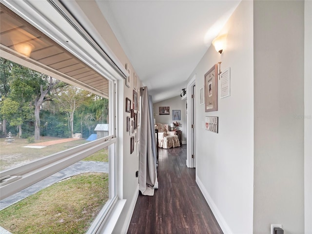 corridor with baseboards and dark wood-style flooring