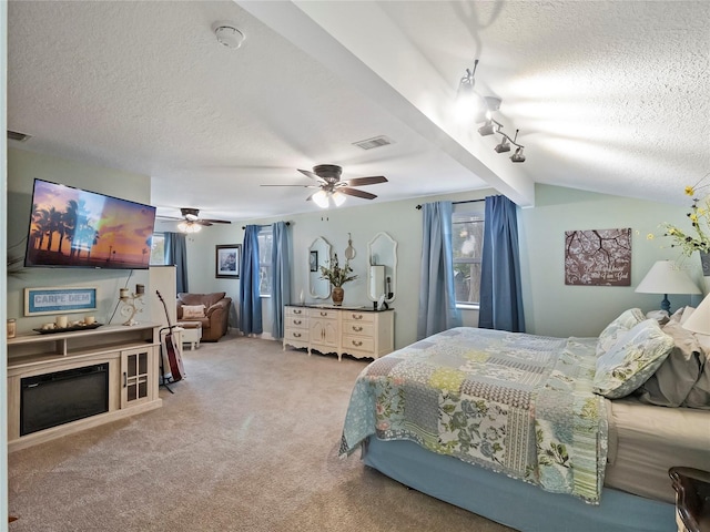 bedroom featuring a ceiling fan, visible vents, track lighting, a textured ceiling, and carpet flooring