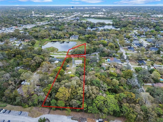 aerial view with a forest view and a water view