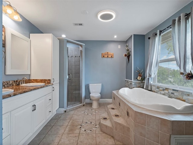 full bath with visible vents, a sink, a garden tub, toilet, and tile patterned floors