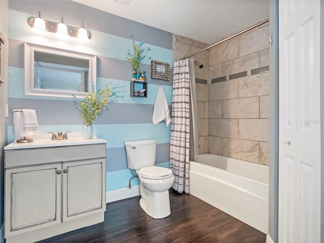 bathroom featuring shower / bathtub combination with curtain, toilet, wood finished floors, baseboards, and vanity