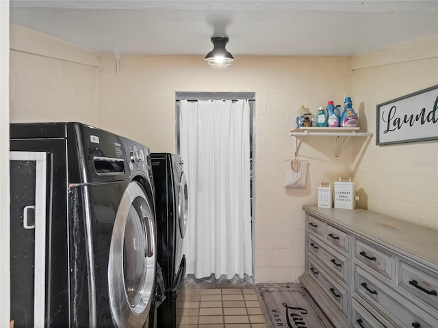 clothes washing area with laundry area, concrete block wall, and separate washer and dryer