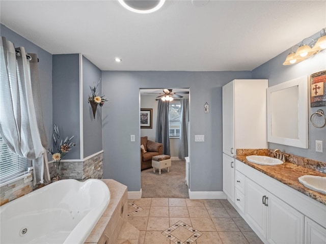500 Forest Lake Dr, Altamonte Springs, FL 32714 - bathroom featuring a tub with jets, double vanity, tile patterned floors, a ceiling fan, and baseboards
