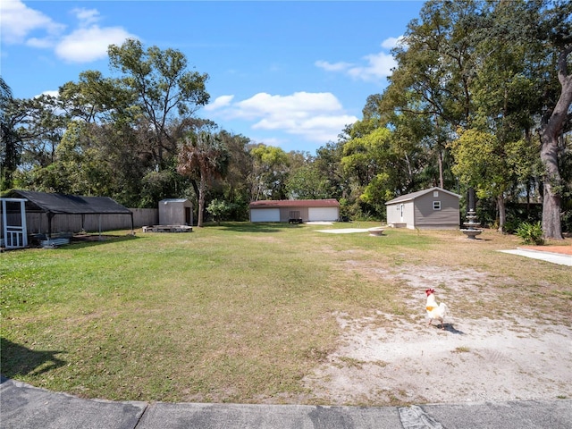 500 Forest Lake Dr, Altamonte Springs, FL 32714 - view of green lawn featuring an outdoor structure, a detached garage, and view of scattered trees