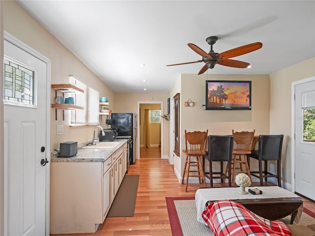 500 Forest Lake Dr, Altamonte Springs, FL 32714 - kitchen with light countertops, light wood-style flooring, freestanding refrigerator, a ceiling fan, and a sink