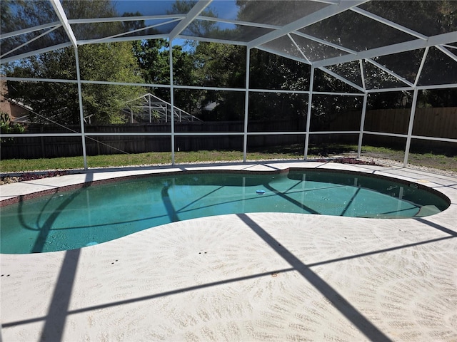 view of swimming pool featuring a lanai, a fenced backyard, a fenced in pool, and a patio