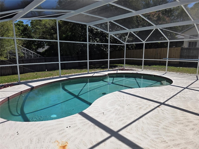 view of swimming pool featuring a patio, a fenced backyard, a fenced in pool, and a lanai