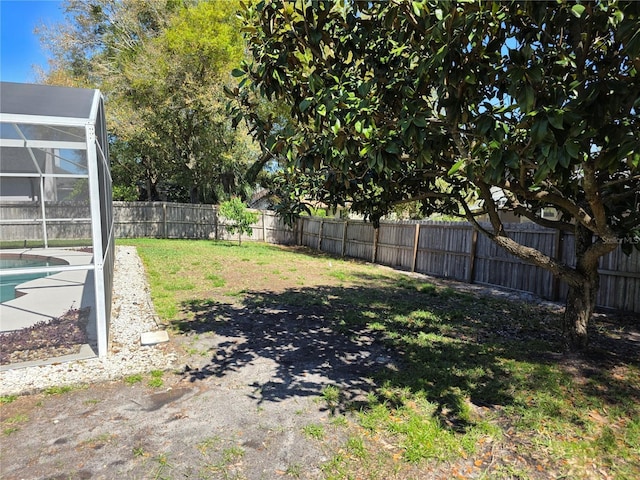 view of yard with glass enclosure, a fenced backyard, and a fenced in pool