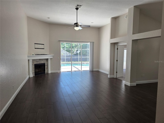 unfurnished living room with baseboards, dark wood-style floors, and a ceiling fan