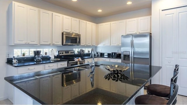 4507 Monado Dr, Kissimmee, FL 34746 - kitchen featuring recessed lighting, appliances with stainless steel finishes, and white cabinets