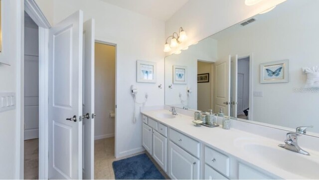 4507 Monado Dr, Kissimmee, FL 34746 - bathroom with a sink, visible vents, double vanity, and tile patterned floors