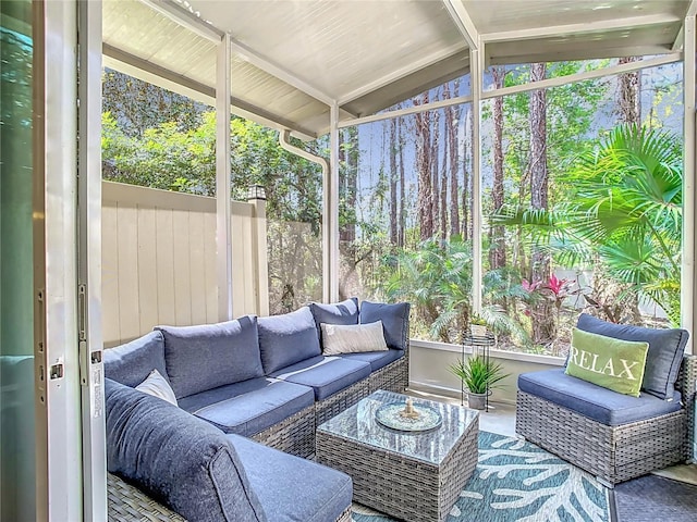 sunroom / solarium featuring a wealth of natural light and vaulted ceiling with beams