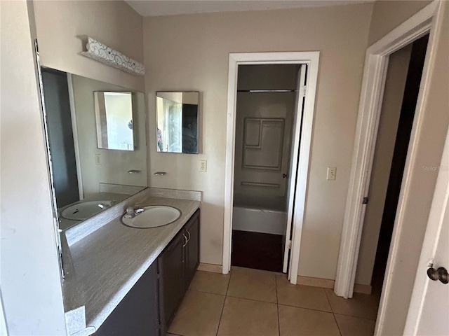 bathroom with baseboards, vanity, and tile patterned flooring