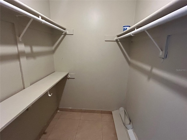 walk in closet featuring light tile patterned flooring