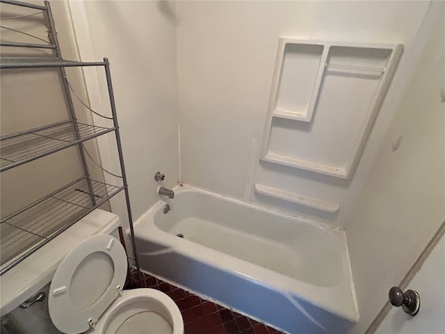 bathroom featuring toilet and  shower combination