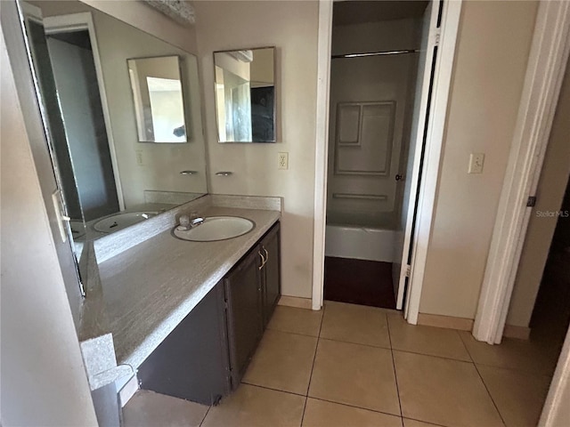 full bath with tile patterned flooring, vanity, and baseboards