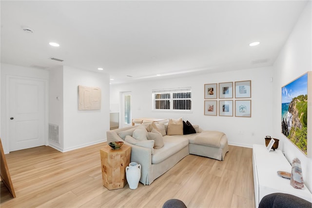 living room with recessed lighting, light wood-style floors, and visible vents