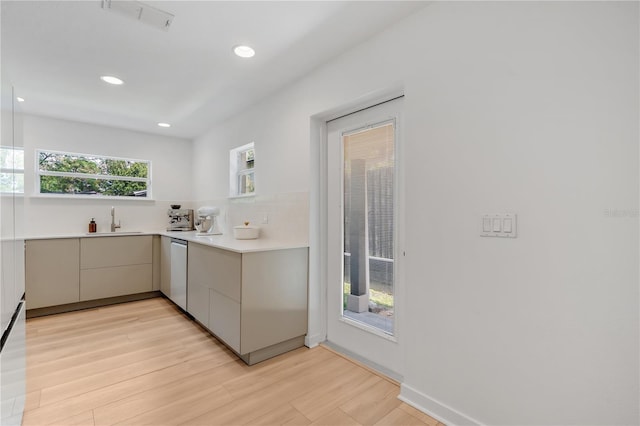 kitchen with visible vents, a sink, light wood-style floors, light countertops, and dishwasher