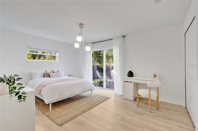 bedroom with access to outside and light wood-style floors