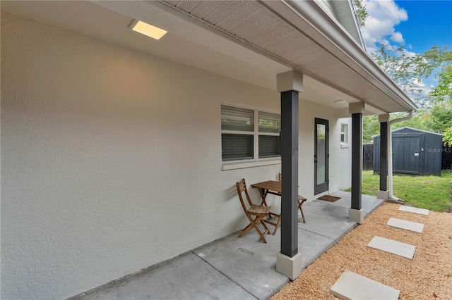 view of patio / terrace featuring a storage unit and an outdoor structure