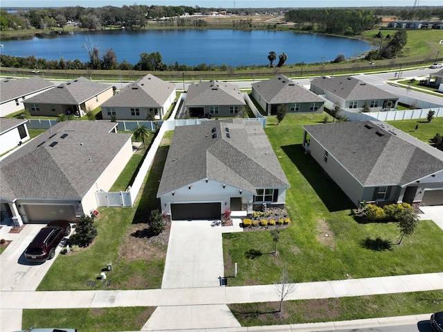 drone / aerial view featuring a residential view and a water view