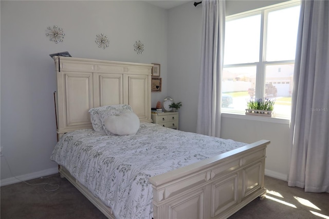 bedroom featuring light colored carpet and baseboards