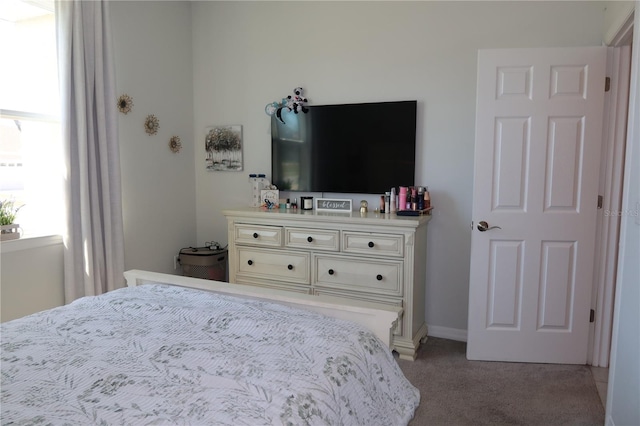 bedroom featuring light colored carpet