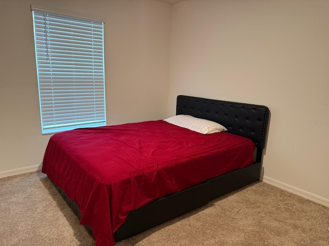 bedroom featuring baseboards and carpet floors