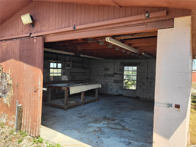 below grade area with a wealth of natural light and concrete block wall