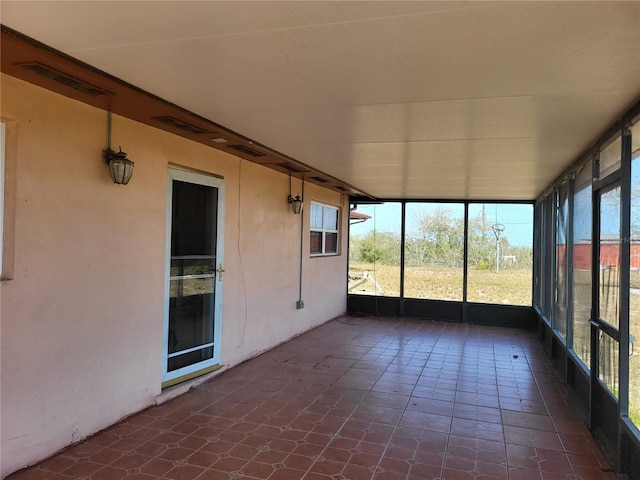 unfurnished sunroom featuring visible vents