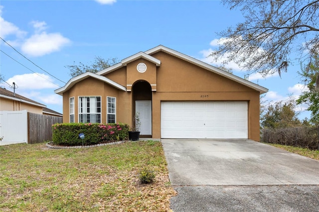 ranch-style house with fence, stucco siding, concrete driveway, a front lawn, and a garage