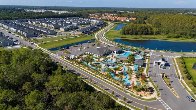 bird's eye view featuring a wooded view and a water view