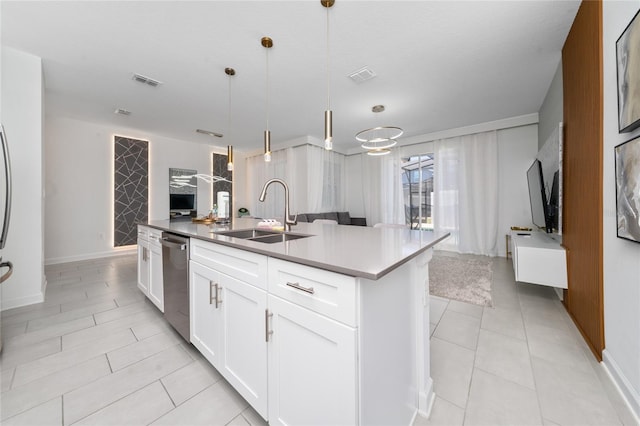 kitchen with a sink, visible vents, pendant lighting, and open floor plan