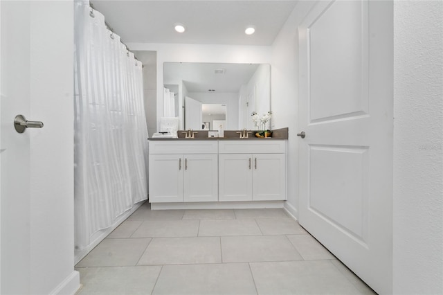 full bathroom featuring tile patterned floors and vanity