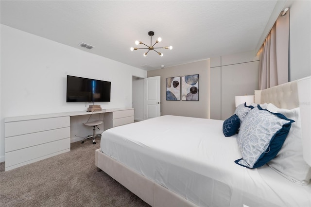 carpeted bedroom with built in study area, visible vents, a closet, and a chandelier