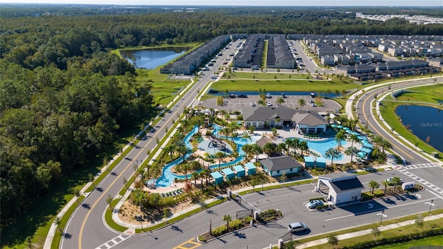 birds eye view of property with a forest view and a water view